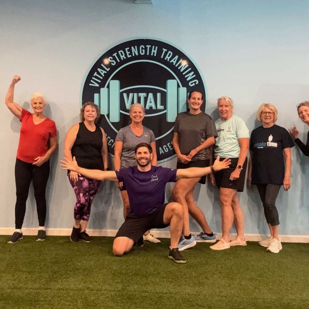 Vital Strength Training class at Thrive Group Strength Training posing with their personal trainer