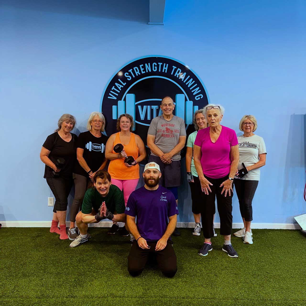 Vital Strength Training class at Thrive Group Strength Training poses with their personal trainer