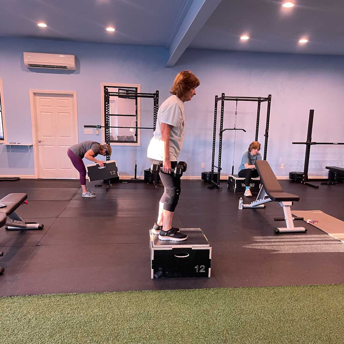 Thrive Group Strength Training member, practicing step aerobics